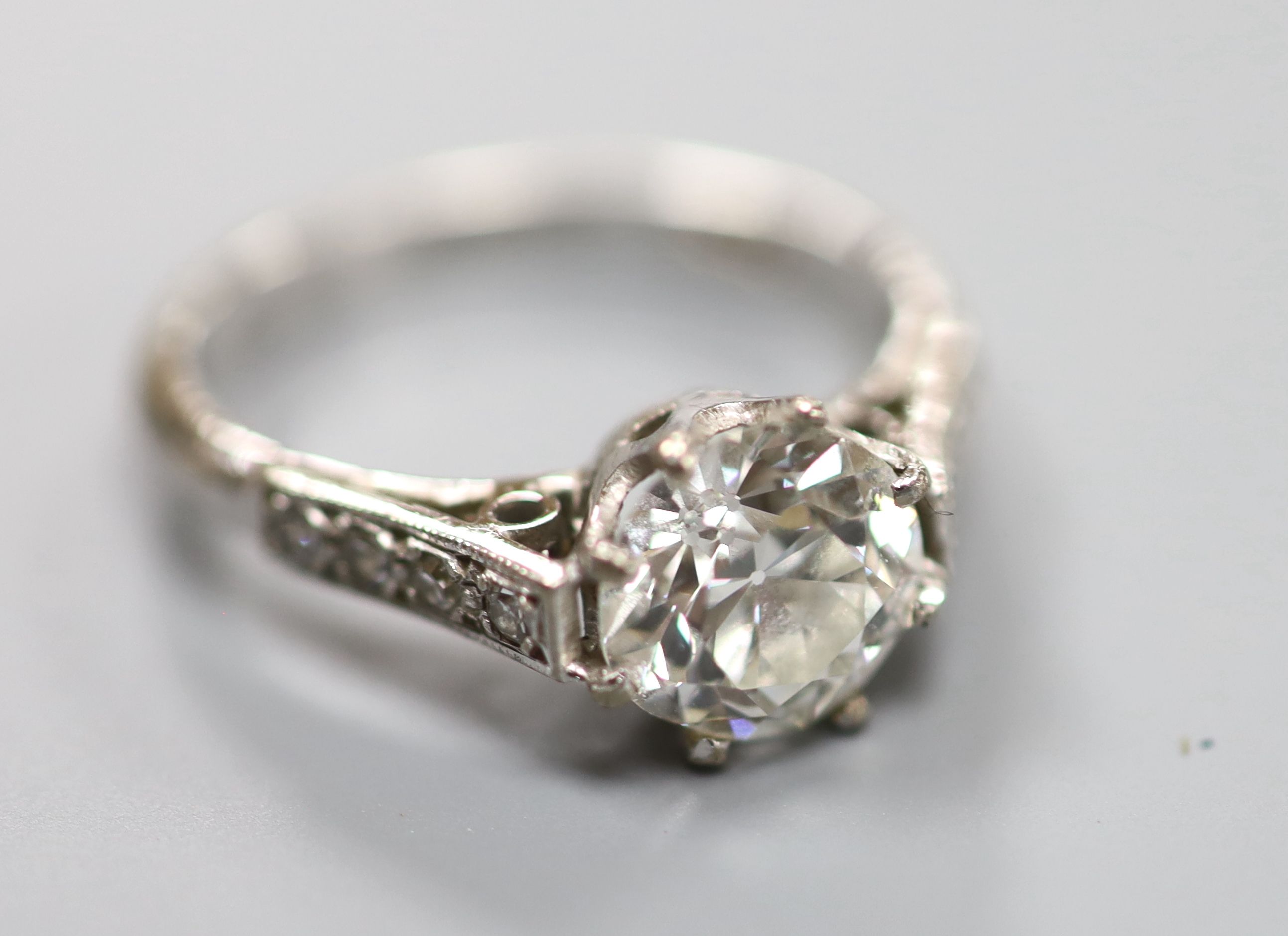 A white metal (stamped 18ct) and single stone diamond ring